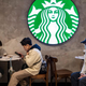 Customers in masks sitting at Starbucks tables